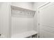Bright mudroom features hooks, shelf, and built-in bench perfect for organizing entry essentials at 537 Steinbeck Pl, Carmel, IN 46032