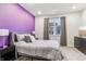 Cozy bedroom with gray bedding and purple accent wall at 6433 Wasco Dr, Whitestown, IN 46075