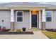 Attractive front entrance with a black door, white columns, and landscaping at 6433 Wasco Dr, Whitestown, IN 46075