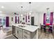 Open concept kitchen with island and stainless steel appliances at 6433 Wasco Dr, Whitestown, IN 46075