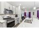 Modern kitchen with stainless steel appliances and an island at 6433 Wasco Dr, Whitestown, IN 46075