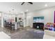 Open living space with a modern kitchen, island seating, and large TV at 6433 Wasco Dr, Whitestown, IN 46075