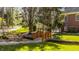 Picturesque backyard featuring a charming wooden bridge, lush greenery, and a glimpse of the pool at 7341 Washington Blvd, Indianapolis, IN 46240