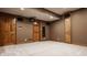 Finished basement featuring projector, speakers, and custom built-in shelving at 7341 Washington Blvd, Indianapolis, IN 46240