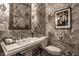 Stylish powder room featuring patterned wallpaper, pedestal sink and modern fixtures at 7341 Washington Blvd, Indianapolis, IN 46240