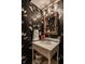 Charming powder room with butterfly wallpaper, unique mirror, and pedestal sink at 7341 Washington Blvd, Indianapolis, IN 46240