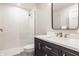 Bathroom featuring black vanity with white countertops and walk-in shower at 7341 Washington Blvd, Indianapolis, IN 46240