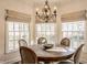 Charming dining room with a round table, elegant chandelier, and bright natural light at 7341 Washington Blvd, Indianapolis, IN 46240