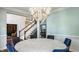 Bright dining area featuring a chandelier, marble table, and staircase view at 7341 Washington Blvd, Indianapolis, IN 46240