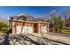 Spacious three-car garage made of brick with ample parking space and a well-maintained driveway at 7341 Washington Blvd, Indianapolis, IN 46240