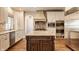 Bright, open kitchen with a center island, custom cabinetry, and stainless steel appliances at 7341 Washington Blvd, Indianapolis, IN 46240