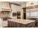 Gourmet kitchen with granite counters, stainless steel appliances, and custom range hood at 7341 Washington Blvd, Indianapolis, IN 46240