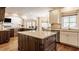 Open kitchen featuring stainless appliances, custom cabinets, and a view into the living area at 7341 Washington Blvd, Indianapolis, IN 46240