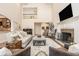 Open-concept living space featuring a fireplace, piano, and an overlooking loft creating a stylish area at 7341 Washington Blvd, Indianapolis, IN 46240