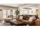 Spacious living area with hardwood floors, large windows, comfortable seating, and a pool table at 7341 Washington Blvd, Indianapolis, IN 46240