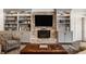 Inviting living room with a fireplace, built-in shelving, and hardwood floors at 7341 Washington Blvd, Indianapolis, IN 46240