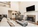 Living room with a fireplace, piano, and high ceilings featuring an airy atmosphere and modern design at 7341 Washington Blvd, Indianapolis, IN 46240
