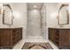 Elegant bathroom with marble shower, double vanity, decorative mirrors and a beautiful patterned rug at 7341 Washington Blvd, Indianapolis, IN 46240