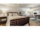 Comfortable main bedroom with tray ceiling, wood floors, and a separate desk area at 7341 Washington Blvd, Indianapolis, IN 46240