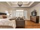 Serene main bedroom with sitting area, hardwood floors, tray ceiling and natural light at 7341 Washington Blvd, Indianapolis, IN 46240