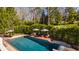 Inviting backyard pool with lounge chairs and patio area surrounded by lush greenery for ultimate relaxation and privacy at 7341 Washington Blvd, Indianapolis, IN 46240