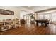Spacious recreation room showcasing a pool table, unique decor, and hardwood floors at 7341 Washington Blvd, Indianapolis, IN 46240