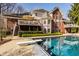 Backyard pool with diving board with a large house in the background at 7341 Washington Blvd, Indianapolis, IN 46240