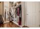 Organized walk-in closet with shelves, hanging rods, and hardwood floors at 7341 Washington Blvd, Indianapolis, IN 46240