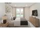 Spacious bedroom with large bed, dresser, and window with natural light at 10349 Gateway Dr, Brownsburg, IN 46234