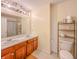 Shared bathroom with double vanity, wood cabinets, and a tiled floor at 10723 Pokagon Way, Indianapolis, IN 46239