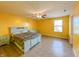 Bedroom with a light teal bed frame and yellow walls, creating a cheerful atmosphere at 10723 Pokagon Way, Indianapolis, IN 46239