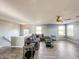Bright bonus room with a sectional sofa and hardwood floors, offering ample living space at 10723 Pokagon Way, Indianapolis, IN 46239