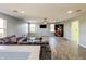 Spacious bonus room with L-shaped sectional sofa, a home office space and hardwood floors at 10723 Pokagon Way, Indianapolis, IN 46239