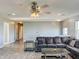 Open concept bonus room featuring a sectional sofa, hardwood floors, and ceiling fan at 10723 Pokagon Way, Indianapolis, IN 46239