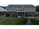 Rear view of home with screened porch and patio at 10723 Pokagon Way, Indianapolis, IN 46239