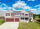 Two-story brick home with red accents and a two-car garage at 10723 Pokagon Way, Indianapolis, IN 46239