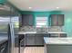 Modern kitchen with gray cabinets, marble countertops, and stainless steel appliances at 10723 Pokagon Way, Indianapolis, IN 46239
