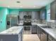 Modern kitchen with grey cabinets, marble countertops, and stainless steel appliances at 10723 Pokagon Way, Indianapolis, IN 46239