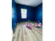 Blue bedroom with wood-look floors and toys at 1243 W 19Th St, Indianapolis, IN 46202