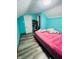 Upstairs bedroom with teal walls and grey wood-look flooring at 1243 W 19Th St, Indianapolis, IN 46202