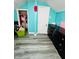 ’s bedroom with teal walls, grey flooring, and closet at 1243 W 19Th St, Indianapolis, IN 46202