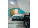 Primary bedroom with teal walls, grey flooring, and crib at 1243 W 19Th St, Indianapolis, IN 46202