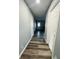 Bright hallway with grey wood-look flooring and white doors at 1243 W 19Th St, Indianapolis, IN 46202