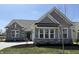 Beautiful single-story home featuring stone accents, gray siding, and a well-manicured lawn, perfect for modern living at 15171 Covebrook Ln, Fishers, IN 46037