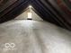 Spacious attic with exposed beams and a window is ready to be transformed at 2029 W 60Th St, Indianapolis, IN 46228