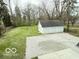 A backyard with a well-maintained lawn and a detached three-car garage offers great potential at 2029 W 60Th St, Indianapolis, IN 46228