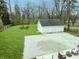 Expansive backyard featuring a detached three car garage and a cozy seating area, ideal for outdoor relaxation and entertainment at 2029 W 60Th St, Indianapolis, IN 46228