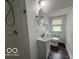 Bathroom with shower, vanity and sink, toilet and window at 2029 W 60Th St, Indianapolis, IN 46228