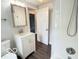 Bathroom with shower and glass door, vanity and sink, toilet and window at 2029 W 60Th St, Indianapolis, IN 46228