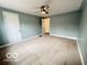 Bedroom with neutral carpet, a ceiling fan, and doorway to hallway at 2029 W 60Th St, Indianapolis, IN 46228